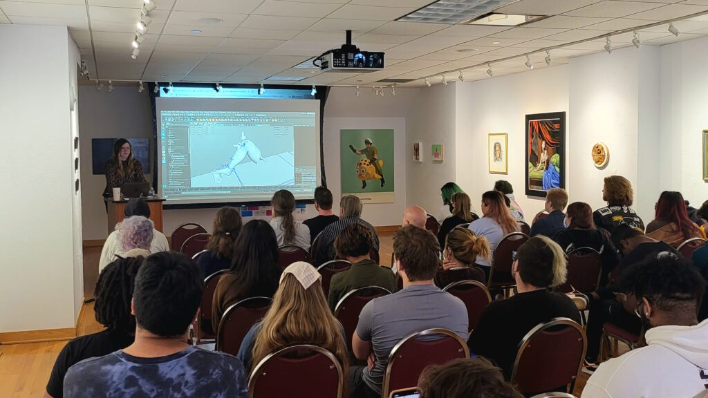 Young woman giving a presentation to a group of college students.